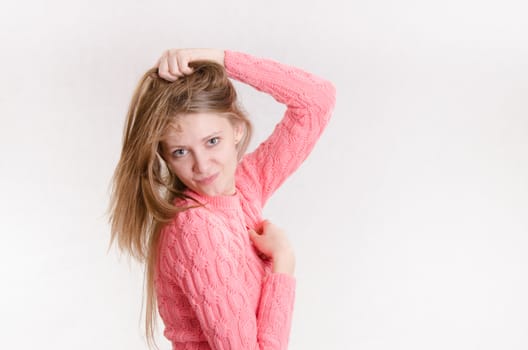 Portrait of a young emotional beautiful girl of the European appearance on a white background
