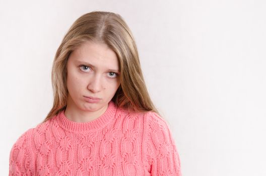 Portrait of a young emotional beautiful girl of the European appearance on a white background