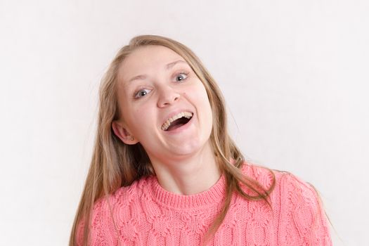 Portrait of a young emotional beautiful girl of the European appearance on a white background