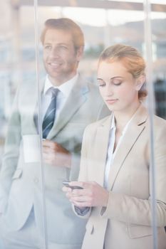 Business people looking out the window at work