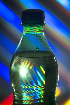 Carbonated lemonade soda bottle on colors background.

