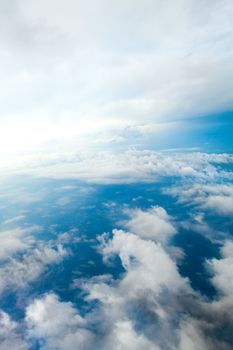 Aerial view of the blue skies and horizon with fluffy clouds and the earth below shot over Tennessee USA.