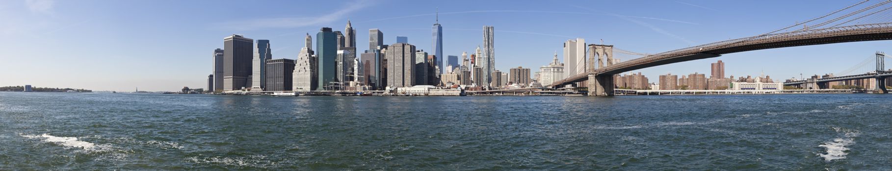 The New York City Downtown panorama at the afternoon w Brooklyn Bridge