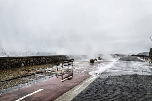 Beautiful shot of a splashing wave in Getaria city, right before the storm.