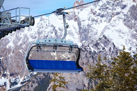 Cable car on the ski resort in Austria. On the background mountain and blue sky.