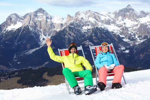 Ski, snow, sun and winter holidays - resting skier in ski resort