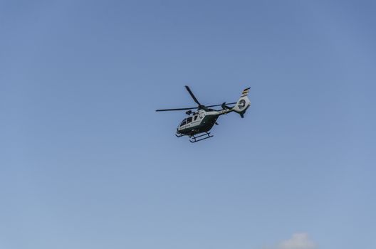 Chopper of Guardia civil patrulling over the mountain in Spain