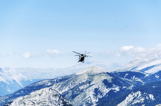 Chopper of Guardia civil patrulling over the mountain in Spain