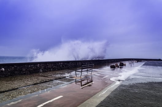 Beautiful shot of a splashing wave in Getaria city, right before the storm.