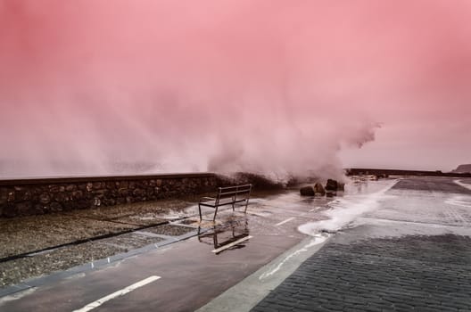 Beautiful shot of a splashing wave in Getaria city, right before the storm.
