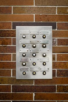 Retro Filter Photo Of Grungy Old Apartment Intercom Or Buzzer Against Brick Wall