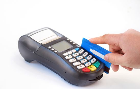hand holding plastic card in payment machine