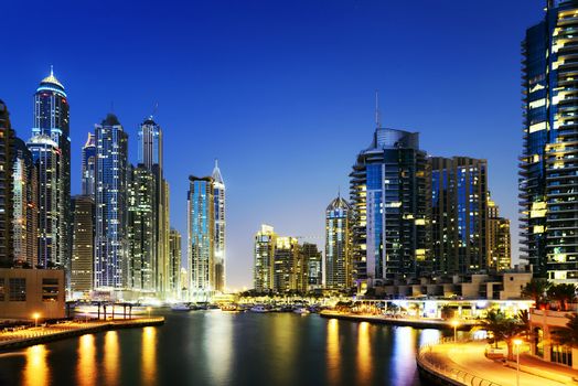 skyline of Dubai Marina at night with boats, United Arab Emirates, Middle East