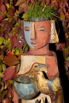 the flower pot in the form of the feminine head