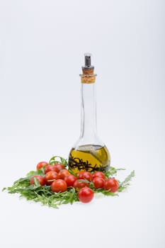 Heap of ruccola, tomatoes and olive oil with the thyme