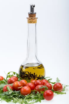 Heap of ruccola, tomatoes and olive oil with the thyme