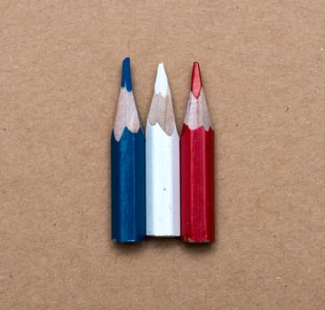 Three small used colored pencils