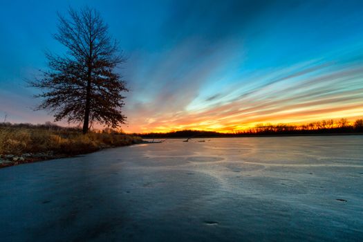 A frozen lake in Missouri during the winter at sunrise