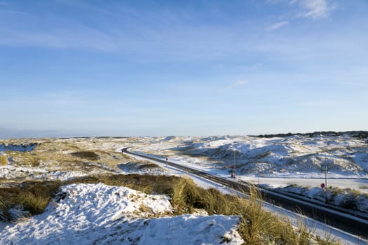 Dune landscape with road in winter in denmark