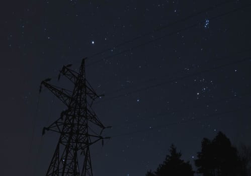 Transmission tower on a background of the starry sky.