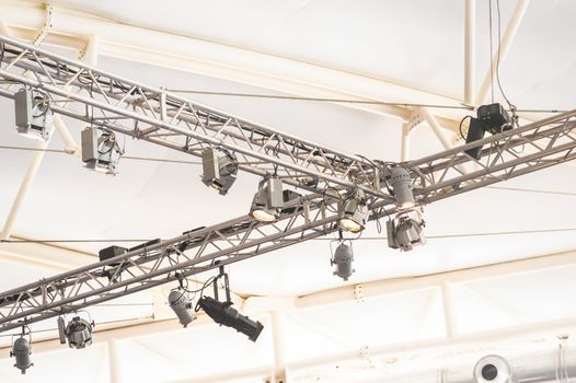 rig lighting projecting bright lights inside a large marquee venue
