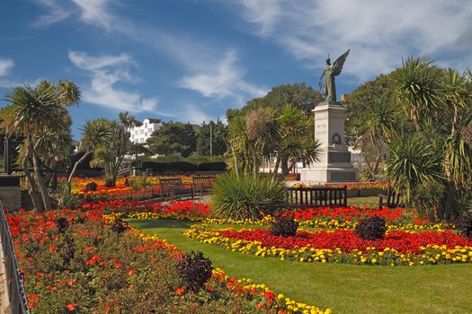 The war memorial at Clacton on Sea in Essex, England is surrounded by a colourful garden.