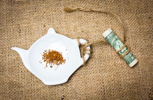 Various type of ingredients poured in several porcelain cups together with a dollar bill