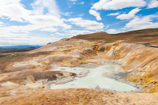 Leirhnjukur is the hot geothermal pool at Krafla area, Iceland. The area around the lake is multicolored and cracked.