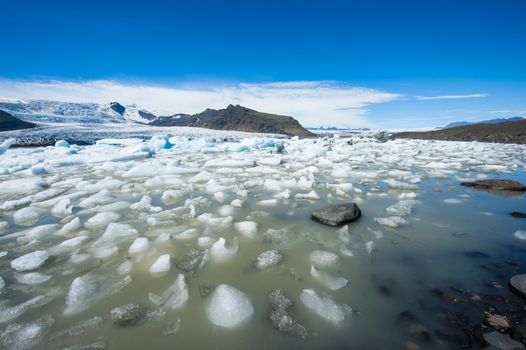 Beautiful photo of Fjallsarlon Glacial lake full of floating icebergs near the Fjallsjokull glacier