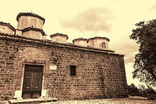Sepia photo of an old Byzantine church of the Saints George at Greece