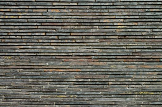 Background of Grey and Brown Plank Stone Exterior Wall closeup