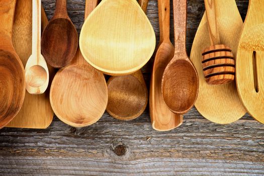 Horizontal Frame of Various Wooden Spoons and Cooking Utensils isolated on Rustic Wooden background