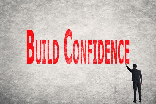 Asian business man write words on wall, Build Confidence