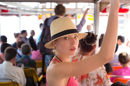 Blonde caucasian lady traveling by public transport.