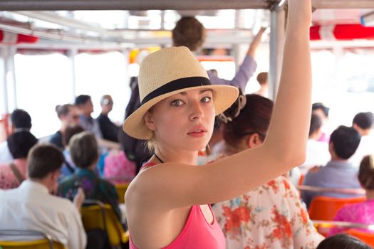 Blonde caucasian lady traveling by public transport.