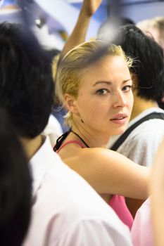 Blonde caucasian lady traveling by public transport.