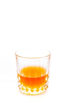 Orange juice into the glass isolated on white