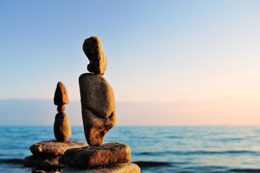 Elongated stones in balance on the seashore