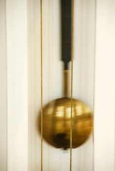 Abstract background of blur gold clocks, vertical shot.