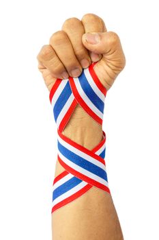 thai man fist and bind thai flag pattern ribbon on forearm on white background(isolated)