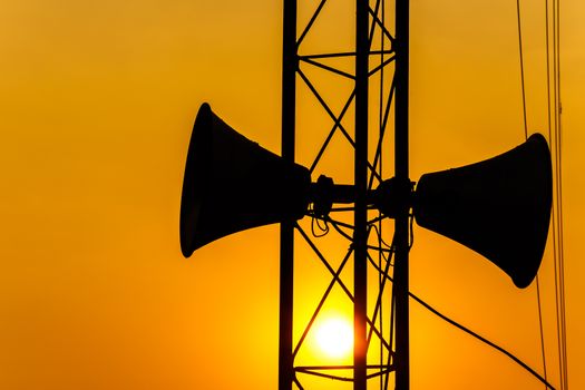 loudspeaker on pillar and sunset in the evening (silhouette) in Thailand