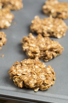 Raw oatmeal cookies on baking sheet, ready for cooking