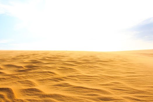 Wave on desert and blue sky at Mui Ne sand dunes, South Vietnam