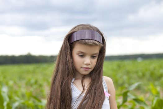 little girl running through the corn field