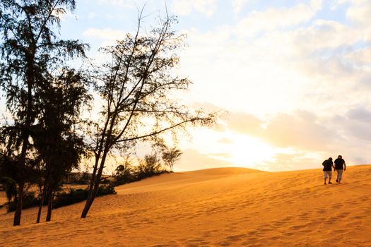 twin asian human are walking on Mui Ne sand dune when sunset ,South Vietnam