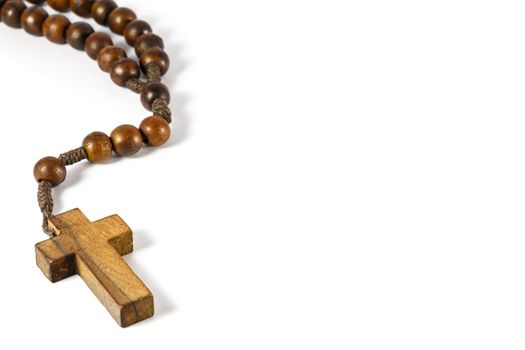 wood rosary with cross at left border and blank area at right side (white background)