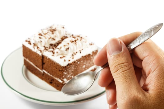 person hold spoon and chocolate cakes on white background