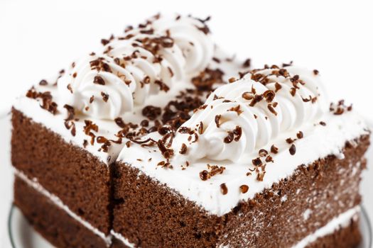 Chocolate cakes with white cream on top on white background