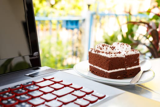 chocolate cakes with white cream on top and notebook computer in house