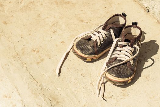 Kid's old canvas shoes in front of rural house ,Thailand